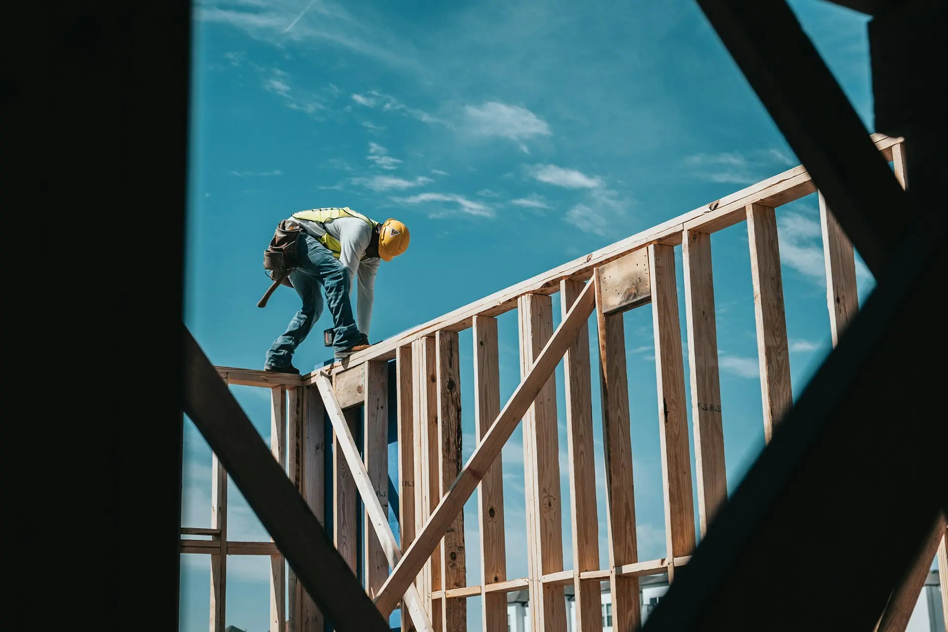 Construction worker framing walls on jobsite